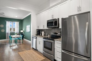 Recently updated kitchen equipped with blender, Keurig coffee machine, and stainless steel appliances.