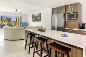 The kitchen is fully-equipped for your holiday catering, offering a central island bench and dishwasher for easy clean up. A dedicated workspace is tucked away in this area.