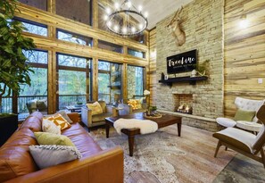 Modern meets rustic in our stylish living room. Perfect for a good book by the fireplace or a fun board game with the crew!