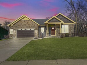 Front yard of the home + 2 car garage.