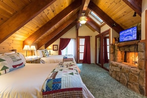 Bedroom with two queen beds and real wood-burning fireplace (upstairs)