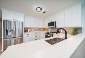 The kitchen features ample counter space and storage, ideal for preparing delicious meals and keeping everything organized.