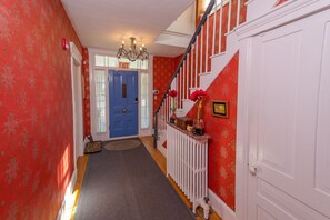 Charming entry with Damask wallpaper