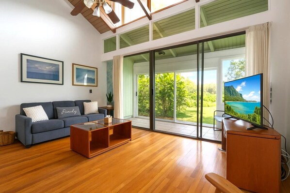 Let sunlight pour through soaring windows as you relax in this airy island retreat with lush views and cozy charm KUL-E113