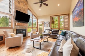 2nd/main level living room with a vaulted ceiling and hardwood floor
