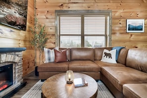 Cozy up by the electric fireplace & enjoy a movie on the 65" flat screen TV