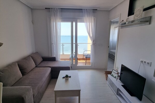 Bright living room with plenty of seating in the sofa bed.