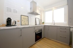 Modern open kitchen is fully fitted with all the appliances