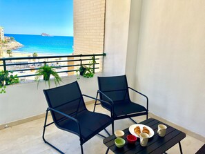 Furnished terrace with chairs and tables, offering spectacular sea views. Perfect for relaxing, dining outdoors, and enjoying the sea breeze.