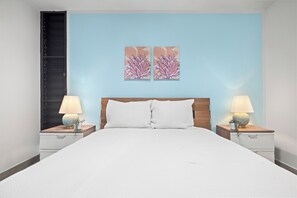Plush queen bed, stylish nightstands & captivating art. Your serene sleep sanctuary.