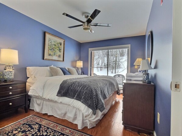 Enjoy the spacious king-size bed with a lovely outdoor view and the gentle breeze of the ceiling fan.