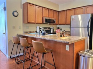 Step into our glamorous kitchen, complete with a sleek refrigerator and elegant table