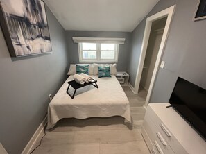 Bedroom with lots of space in closet(hard to tell from photo)  