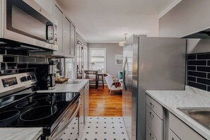 Newly renovated gourmet kitchen is stocked with coffee, filtered water, snacks, cooking ware and everything you need. 