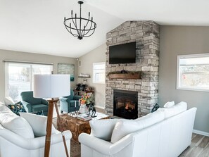 Cozy up and catch a flick or a good read on our comfortable genuine leather sofas. No neck strain here.. our fireplace Tv mount is adjustable to eye level. Stunning views of the lake from the main living area. 