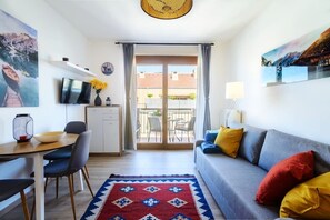 Living room with balcony and dining area