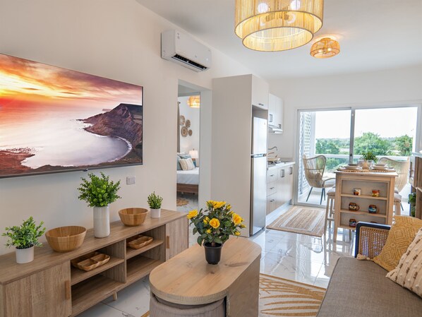 Relax in style! Our cozy living room features a plush 58-inch flat-screen TV—perfect for movie nights or catching up on your favorite shows.
