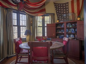 You'll love the ambiance of the dining room, located on the 2nd floor in the apartment~ with the warmth of the antique flags and nautical lanterns, you'll love this space~ a generous sized table brings you and your loved ones together for entertaining and playing board games. Table has four large chairs and various stools and will seat 8 guests comfortably. 