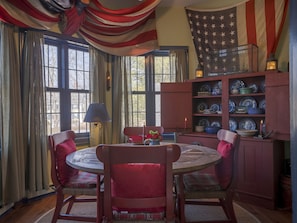 You'll love the ambiance of the dining room, located on the 2nd floor in the apartment~ with the warmth of the antique flags and nautical lanterns, you'll love this space~ a generous sized table brings you and your loved ones together for entertaining and playing board games. Table has four large chairs and various stools and will seat 8 guests comfortably.