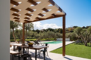 The terrace with al fresco seating overlooking the pool.  
