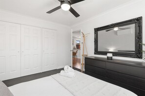 Main bedroom with ceiling fan and AC/heating