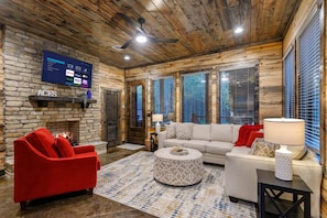 The living space includes a flat-screen Smart TV with streaming capabilities and plenty of seating options.