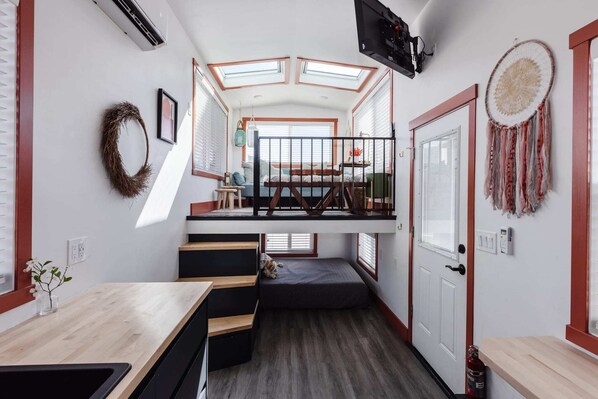 Relax in the inviting living room featuring a comfortable couch,  and a TV for entertainment. A sofa bed provides extra sleeping space, and with Wi-Fi access, this space is perfect for unwinding or enjoying your favorite shows and movies.