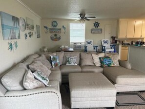 Living room with couch and big screen television.  Popcorn for Movie night.