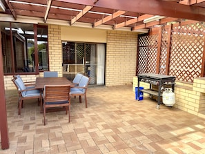 Outdoor dining area with gas BBQ