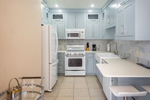 Step into a serene culinary haven! ✨ Our kitchen with sleek white cabinets brings elegance and functionality together.