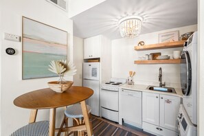 With full kitchen, washer, and dryer