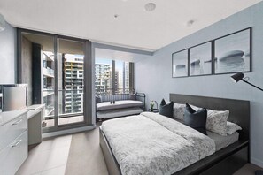 A cozy studio with a queen sized bed & plush pillows.