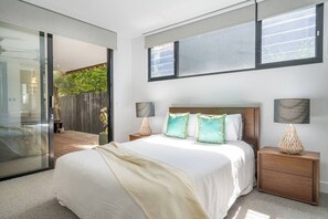 The primary bedroom features a queen-sized bed, wardrobe space for your belongings, and your own TV.
