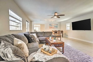 The living space includes a large sofa and a flat-screen TV for movie nights.