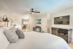 The primary bedroom includes a queen-size bed and a flat-screen TV to watch from bed.