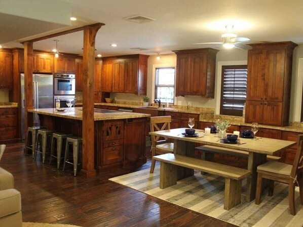 Well stocked and equipped kitchen with breakfast bench.  