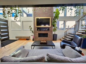 View of the frame tv from behind living room sofa