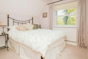 2nd bedroom with double bed and view of garden and en-suite shower room.