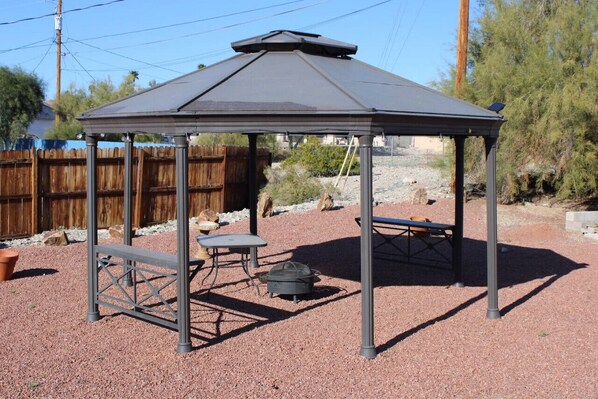 Covered area with fire pit.
