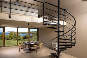 The living space on the first floor has a round dining table seating 10.