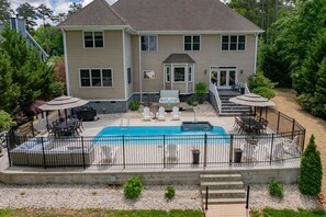 Fenced in Pool area, hot tub, fire pit, lounge area, (2) 8 person dining tables