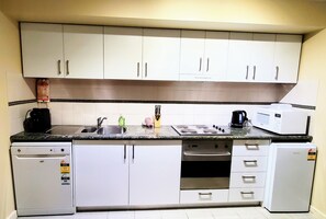 Fully stocked kitchen with dishwasher. 