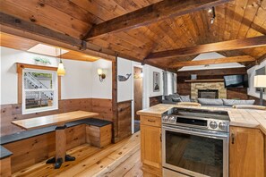 View from the location of the refrigerator, you can see the stove, dining nook, and first family room with smart TV