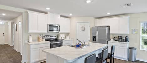 Enjoy Making Dinner In This Fully Stocked Kitchen With Additional Counter Seating