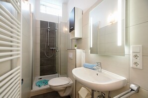 Badezimmer mit WC, Waschbecken und Dusche