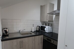 Behold our communal kitchen and dining area—where meals are shared, laughter echoes, and friendships blossom. 