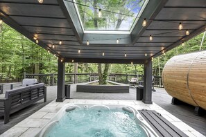 Step into the soothing waters of our hot tub, nestled on a patio that serves as a private sanctuary for relaxation and rejuvenation.