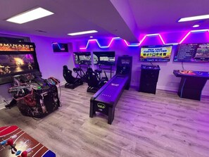 Classic meets modern in this arcade nook, where Golden Tee invites guests to tee off surrounded by the glow of neon.