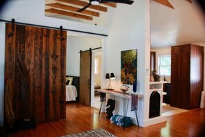 The gas fireplace keeps the home warm and cozy through the colder months. The open floor plan and raised ceiling help with airflow, keeping it cool in the summer! Sliding rustic barn doors give you the option of added privacy as well. 