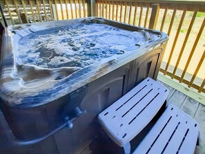 Relax in the bubbly hot tub after a fun day at the beach!